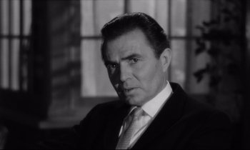 Movie still from “Lolita” (1962), directed by Stanley Kubrick – Black and white photograph of a man wearing a suit; Close Up shot, Over the shoulder angle