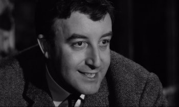 Movie still from “Lolita” (1962), directed by Stanley Kubrick – Black and white photograph of a man smiling; Close Up shot, Low angle