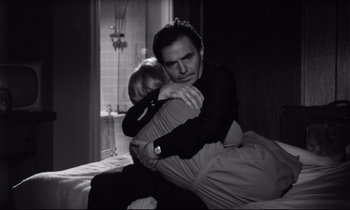 Movie still from “Lolita” (1962), directed by Stanley Kubrick – A black and white photo of a man hugging a child; Medium shot, High angle