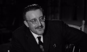 Movie still from “Lolita” (1962), directed by Stanley Kubrick – An older man wearing a suit and tie; Close Up shot, Low angle