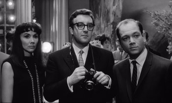 Movie still from “Lolita” (1962), directed by Stanley Kubrick – A black and white photo of a man holding a camera; Medium shot, Low angle