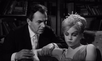 Movie still from “Lolita” (1962), directed by Stanley Kubrick – A man and a woman are looking at each other; Close Up shot, Over the shoulder angle