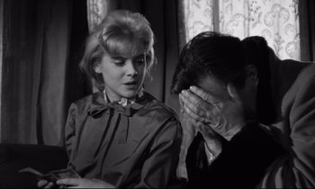 Movie still from “Lolita” (1962), directed by Stanley Kubrick – An old photo of a man and a woman; Close Up shot, Over the shoulder angle