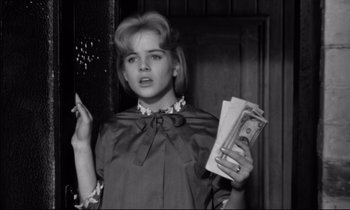 Movie still from “Lolita” (1962), directed by Stanley Kubrick – A young woman holding a bunch of money; Close Up shot, Low angle