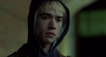 Movie still from “London Boulevard” (2010), directed by William Monahan – A young man with blonde hair wearing a hooded sweatshirt; Close Up shot, Low angle