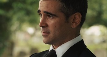 Movie still from “London Boulevard” (2010), directed by William Monahan – A person wearing a suit and tie; Close Up shot, Over the shoulder angle