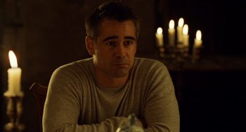 Movie still from “London Boulevard” (2010), directed by William Monahan – A man sitting in front of candles in a dimly - lit room; Close Up shot, Over the shoulder angle