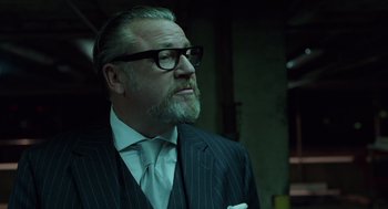 Movie still from “London Boulevard” (2010), directed by William Monahan – A man in a suit and tie looking up; Close Up shot, Low angle