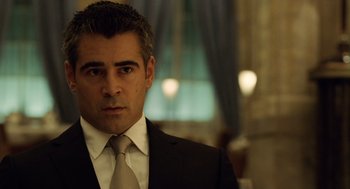Movie still from “London Boulevard” (2010), directed by William Monahan – A person wearing a suit and tie; Close Up shot, Over the shoulder angle