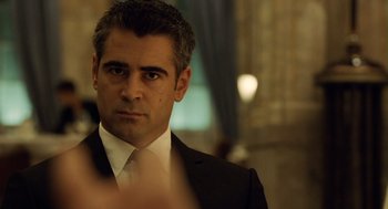 Movie still from “London Boulevard” (2010), directed by William Monahan – A person wearing a suit and tie; Close Up shot, Over the shoulder angle