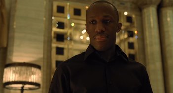Movie still from “London Boulevard” (2010), directed by William Monahan – A man wearing a black shirt and a black tie; Close Up shot, Low angle