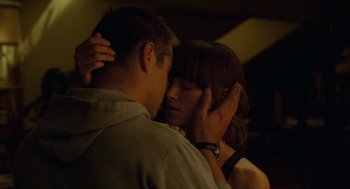 Movie still from “London Boulevard” (2010), directed by William Monahan – A man and a woman embracing each other in the dark; Close Up shot, Low angle