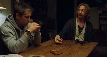 Movie still from “London Boulevard” (2010), directed by William Monahan – Two men sitting at a wooden table playing a game; Medium shot, Over the shoulder angle