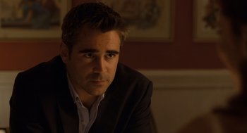 Movie still from “London Boulevard” (2010), directed by William Monahan – A person wearing a suit and tie; Close Up shot, Over the shoulder angle