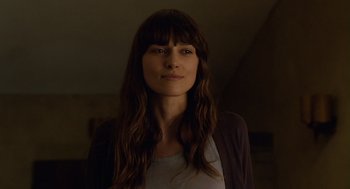 Movie still from “London Boulevard” (2010), directed by William Monahan – A beautiful woman with long brown hair wearing a white shirt; Close Up shot, Low angle