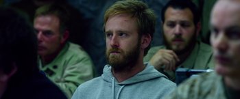 Movie still from “Lone Survivor” (2013), directed by Peter Berg – A man with a goatee is looking to his left; Close Up shot, Over the shoulder angle