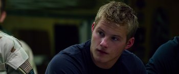 Movie still from “Lone Survivor” (2013), directed by Peter Berg – A person sitting down; Close Up shot, Over the shoulder angle