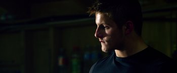 Movie still from “Lone Survivor” (2013), directed by Peter Berg – A young man is looking to his left; Close Up shot, Low angle