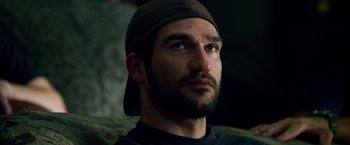 Movie still from “Lone Survivor” (2013), directed by Peter Berg – A person wearing a hat; Close Up shot, Low angle