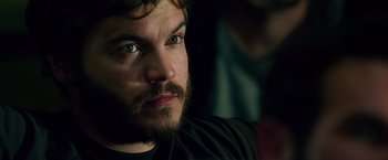 Movie still from “Lone Survivor” (2013), directed by Peter Berg – A person with a beard looking at the camera; Close Up shot, Over the shoulder angle