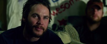 Movie still from “Lone Survivor” (2013), directed by Peter Berg – A person sitting on a couch; Close Up shot, Over the shoulder angle