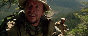Movie still from “Lone Survivor” (2013), directed by Peter Berg – A person wearing a hat; Close Up shot, Over the shoulder angle