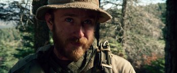 Movie still from “Lone Survivor” (2013), directed by Peter Berg – A person wearing a hat; Close Up shot, Over the shoulder angle