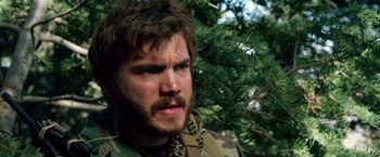 Movie still from “Lone Survivor” (2013), directed by Peter Berg – A person with a beard; Close Up shot, Over the shoulder angle