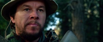 Movie still from “Lone Survivor” (2013), directed by Peter Berg – A person wearing a hat; Close Up shot, Low angle