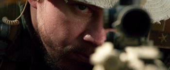Movie still from “Lone Survivor” (2013), directed by Peter Berg – A man with a beard and a bandage on his head; Extreme Close Up shot, Over the shoulder angle
