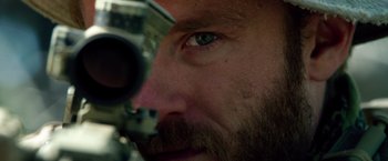 Movie still from “Lone Survivor” (2013), directed by Peter Berg – A man's eye with a rifle in it; Extreme Close Up shot, Over the shoulder angle