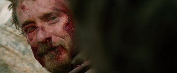 Movie still from “Lone Survivor” (2013), directed by Peter Berg – A person with blood on his face; Close Up shot, Over the shoulder angle