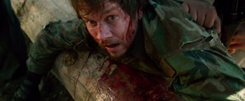 Movie still from “Lone Survivor” (2013), directed by Peter Berg – A person with blood all over his face; Close Up shot, Overhead angle