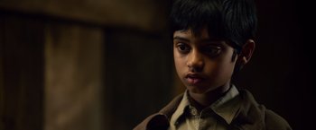 Movie still from “Lone Survivor” (2013), directed by Peter Berg – A young boy is looking into the camera; Close Up shot, High angle