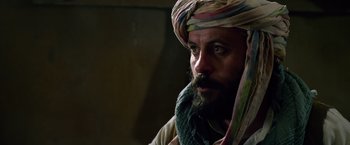 Movie still from “Lone Survivor” (2013), directed by Peter Berg – A man with a beard wearing a turban; Close Up shot, Over the shoulder angle