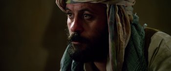 Movie still from “Lone Survivor” (2013), directed by Peter Berg – A man with a beard wearing a head covering; Close Up shot, Over the shoulder angle