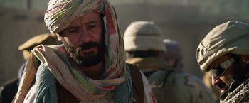 Movie still from “Lone Survivor” (2013), directed by Peter Berg – A man with a beard wearing a turban; Close Up shot, Over the shoulder angle