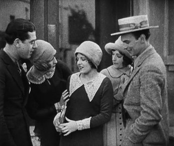Movie still from “Lonesome” (1928), directed by Pál Fejös – A group of people standing next to each other on the street; Medium shot, High angle
