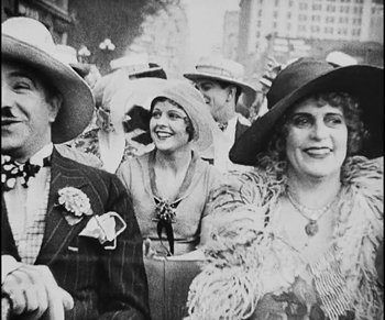 Movie still from “Lonesome” (1928), directed by Pál Fejös – A black and white photo of a group of people wearing hats; Close Up shot, Low angle