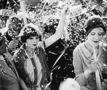 Movie still from “Lonesome” (1928), directed by Pál Fejös – A black and white photo of a group of people; Medium shot, Low angle