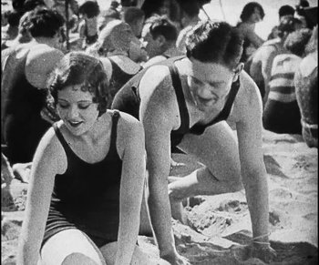Movie still from “Lonesome” (1928), directed by Pál Fejös – A couple of people that are in the sand; Medium shot, Low angle