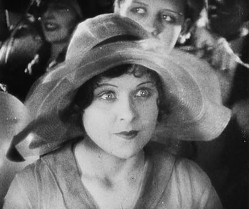 Movie still from “Lonesome” (1928), directed by Pál Fejös – An old photo of a woman wearing a large hat; Close Up shot, High angle