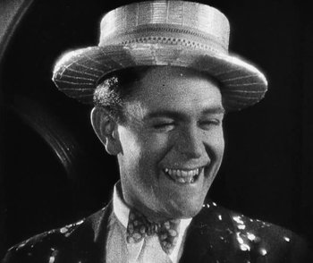 Movie still from “Lonesome” (1928), directed by Pál Fejös – A man wearing a sequined jacket and a hat; Close Up shot, Low angle