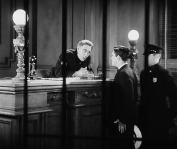 Movie still from “Lonesome” (1928), directed by Pál Fejös – Two men are standing at a counter in a courtroom; Medium shot, Low angle