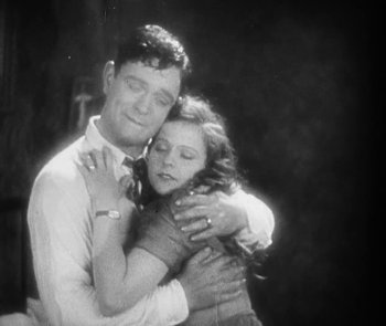 Movie still from “Lonesome” (1928), directed by Pál Fejös – A man and a woman embracing each other; Medium shot, High angle