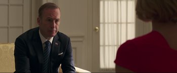 Movie still from “Long Shot” (2019), directed by Jonathan Levine – A man sitting in front of another man in a room; Close Up shot, Over the shoulder angle