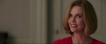 Movie still from “Long Shot” (2019), directed by Jonathan Levine – A person with a smile on their face; Close Up shot, Over the shoulder angle