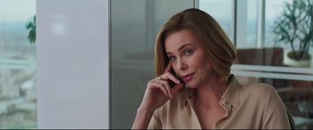 Movie still from “Long Shot” (2019), directed by Jonathan Levine – A woman is talking on a cell phone; Close Up shot, Over the shoulder angle
