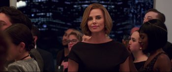 Movie still from “Long Shot” (2019), directed by Jonathan Levine – Charlize theron wearing a black dress; Medium shot, Over the shoulder angle