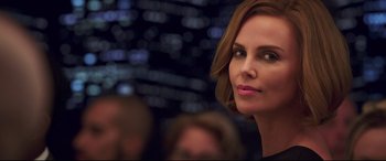 Movie still from “Long Shot” (2019), directed by Jonathan Levine – A person wearing a black shirt; Close Up shot, Over the shoulder angle